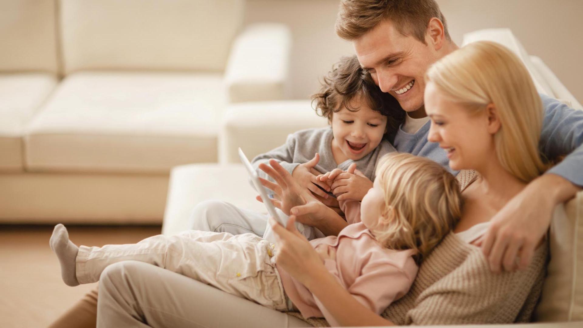 a young family looking at tablet together