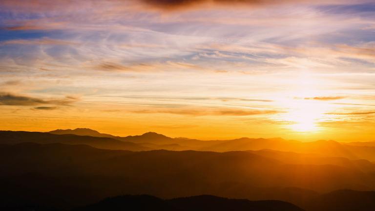 blue color of mountains during sunset